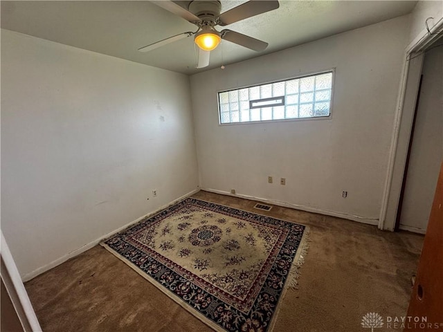 carpeted spare room with ceiling fan