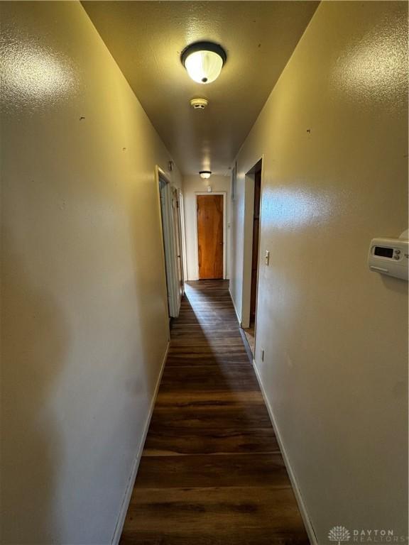 hall with dark wood-type flooring