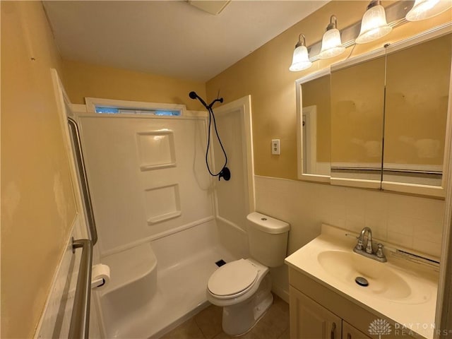 bathroom with vanity, a shower, backsplash, tile patterned flooring, and toilet