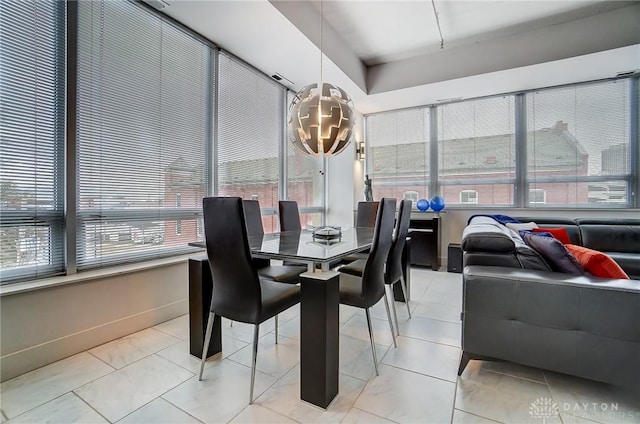 dining room featuring plenty of natural light and light tile patterned flooring