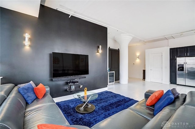 living room featuring a barn door and beverage cooler