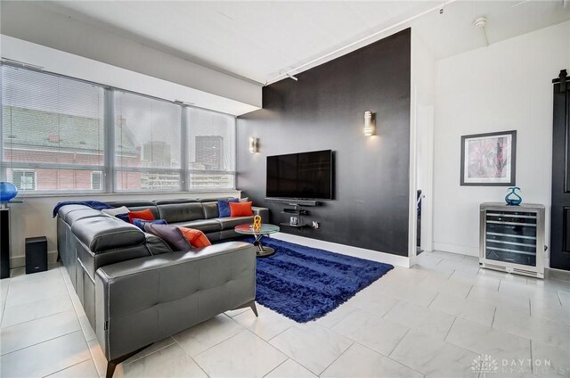 tiled living room with a barn door and beverage cooler