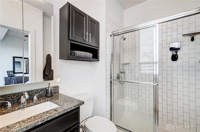 bathroom with vanity, toilet, and walk in shower