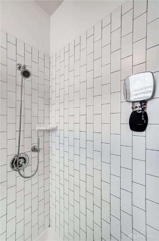 bathroom with tiled shower