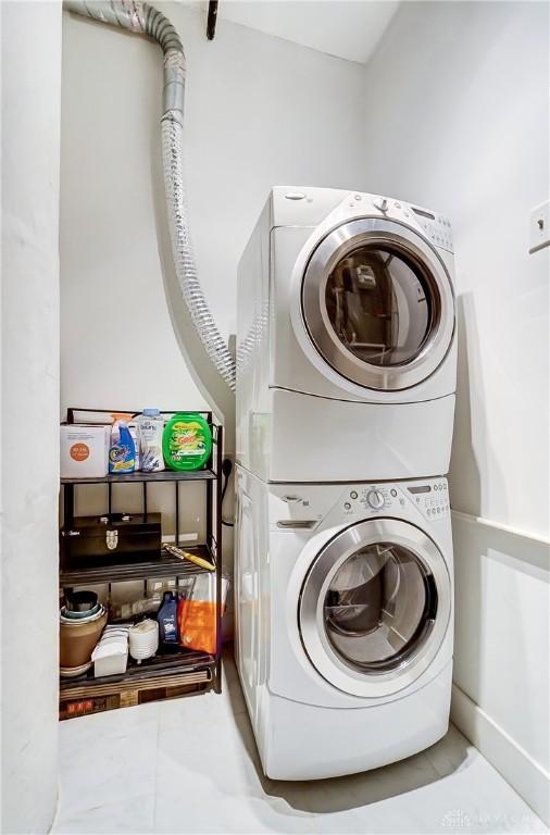 laundry area with stacked washer and dryer