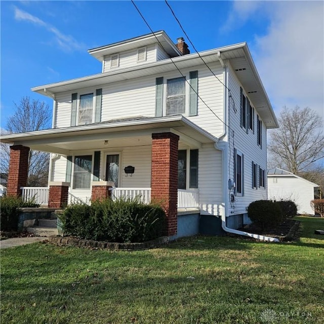 view of front of house with covered porch and a front lawn