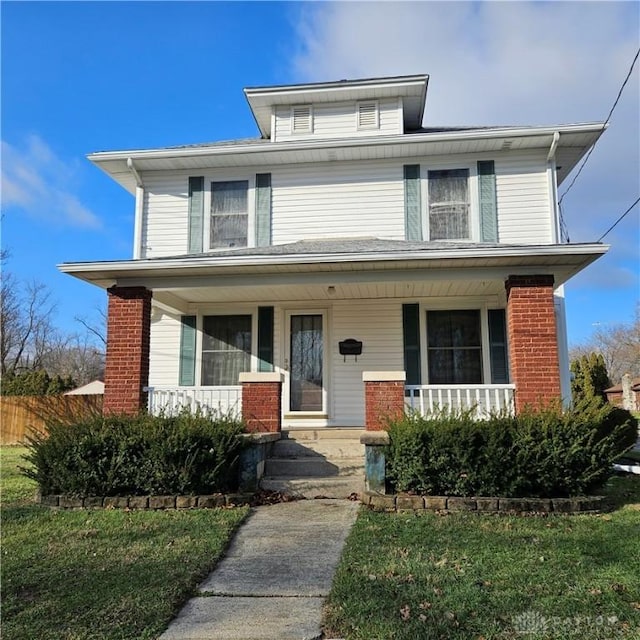 view of front of house with a porch and a front yard