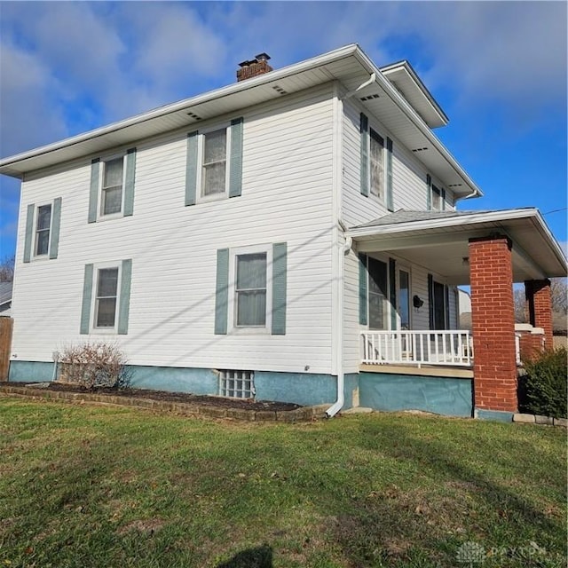 view of home's exterior featuring a porch and a lawn