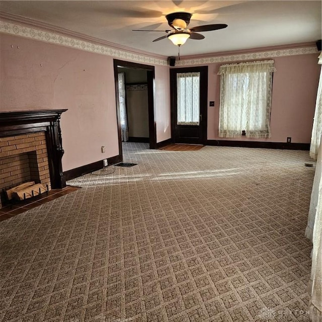 unfurnished living room featuring crown molding, a fireplace, ceiling fan, and carpet