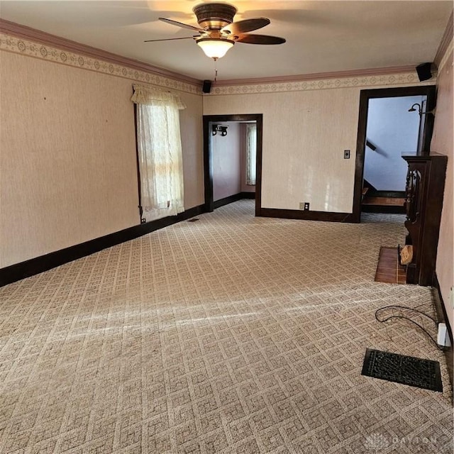 empty room featuring crown molding and ceiling fan