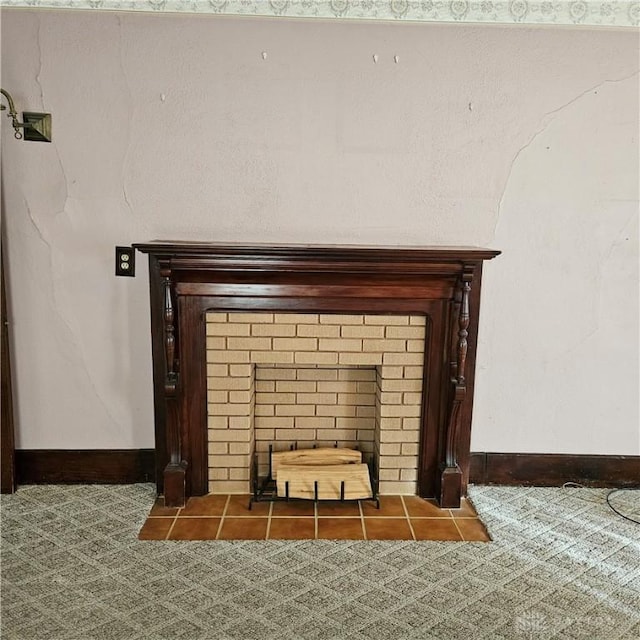 room details featuring a brick fireplace and carpet floors