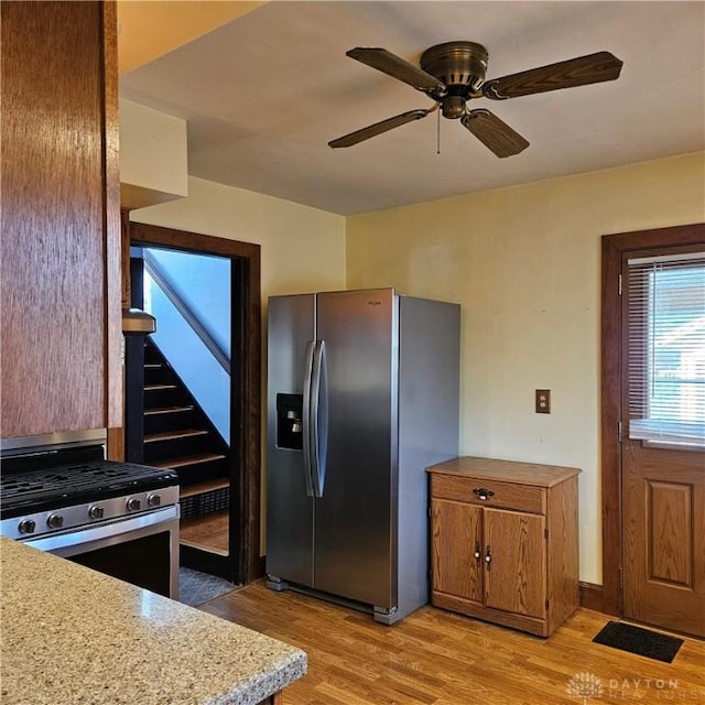 kitchen with ceiling fan, appliances with stainless steel finishes, and light hardwood / wood-style flooring