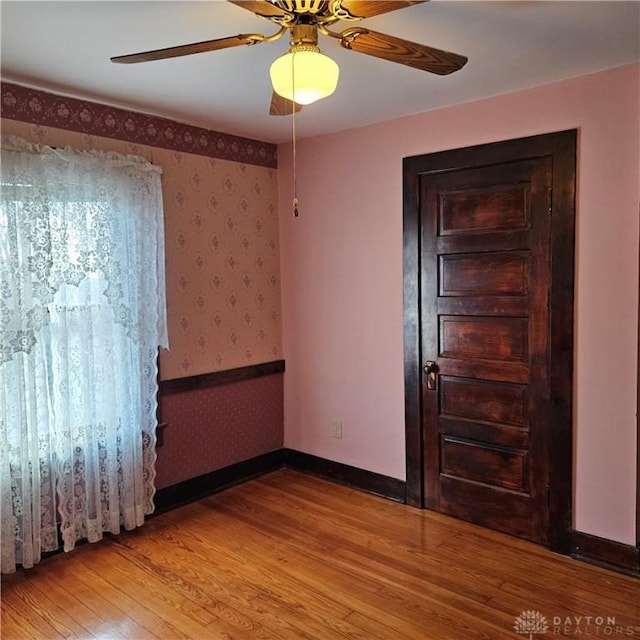 spare room featuring ceiling fan and light wood-type flooring