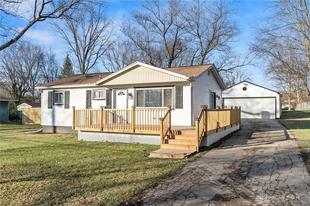 view of front of house featuring a garage, an outbuilding, and a front lawn