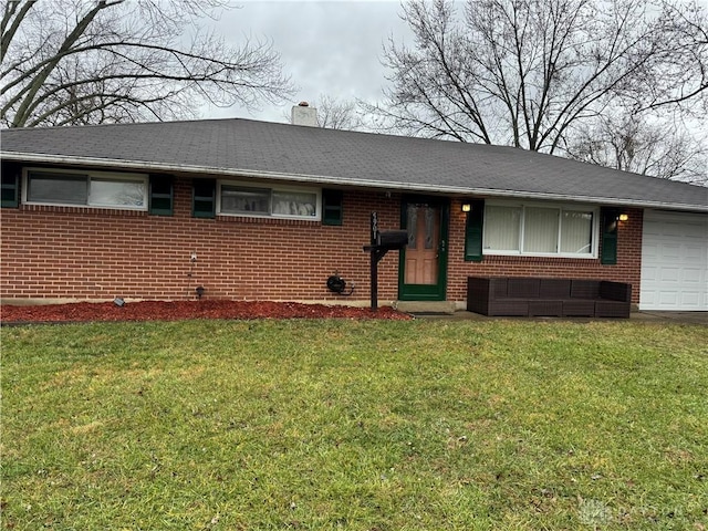 single story home with a front yard and a garage