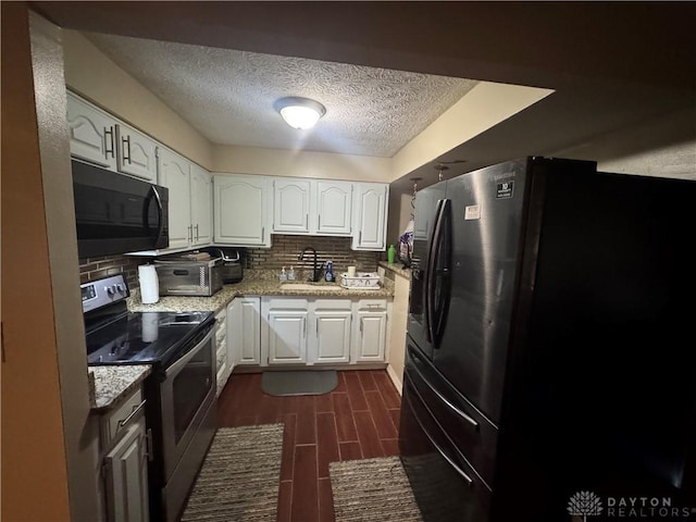 kitchen featuring white cabinetry, fridge, stainless steel range with electric cooktop, and sink