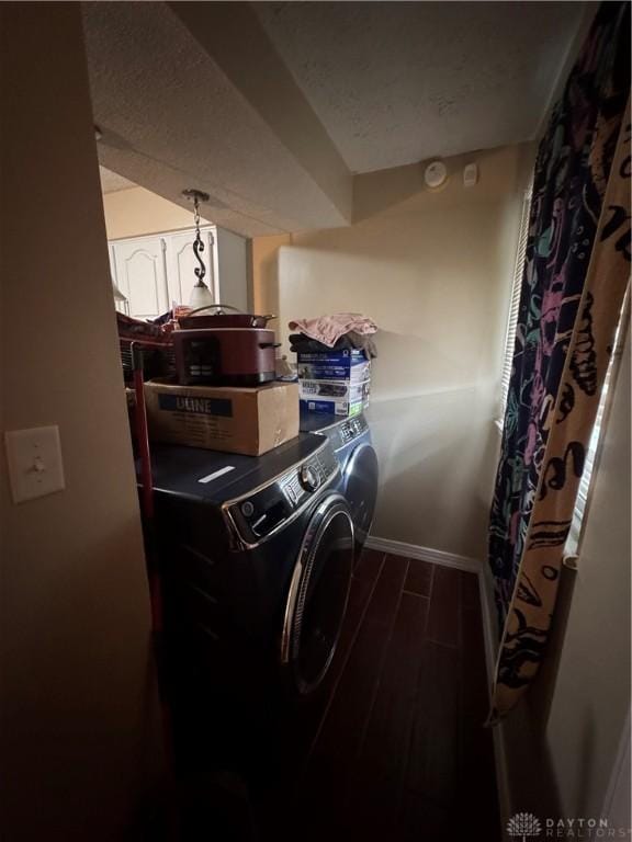 clothes washing area featuring washer and dryer and a textured ceiling