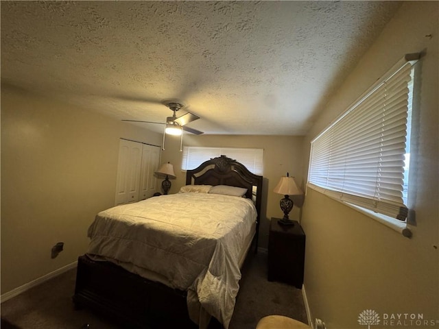 carpeted bedroom featuring ceiling fan, a textured ceiling, and a closet