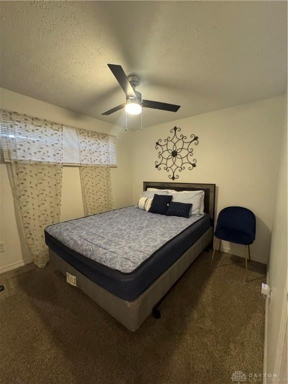 bedroom with carpet, a textured ceiling, and ceiling fan