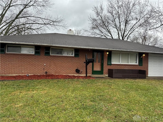 single story home with a front yard and a garage