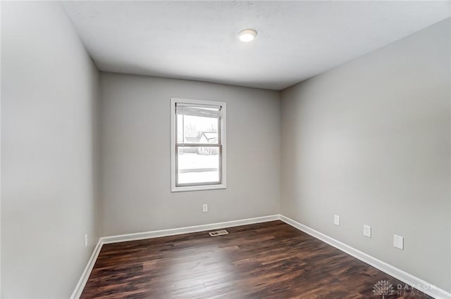 spare room featuring dark hardwood / wood-style floors