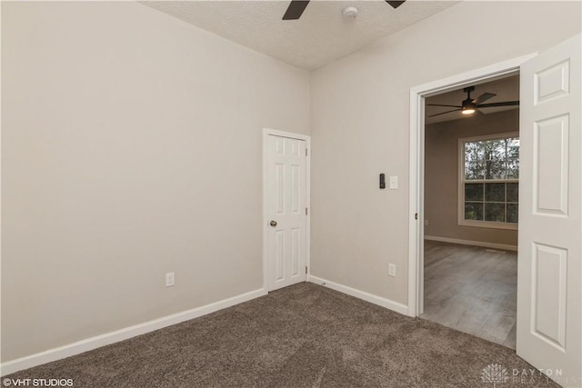 empty room featuring carpet flooring, ceiling fan, and a textured ceiling