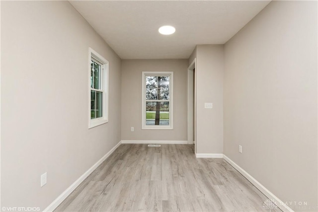 spare room featuring light hardwood / wood-style floors