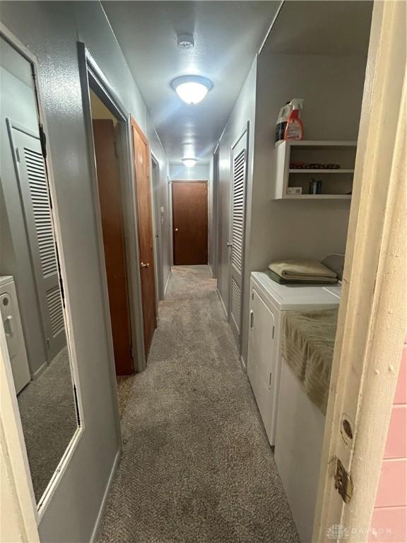 hallway with carpet flooring and washing machine and dryer