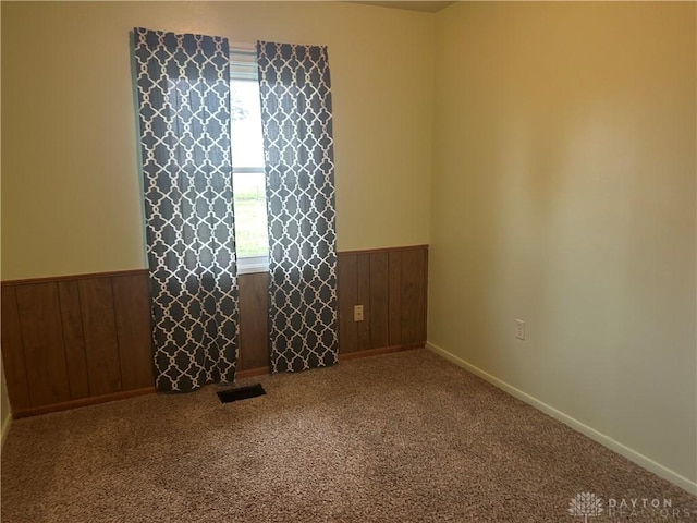 carpeted spare room featuring plenty of natural light