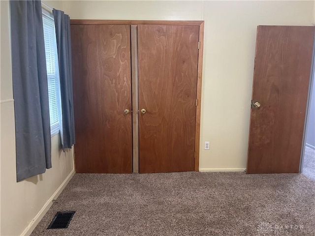 unfurnished bedroom with a closet and carpet