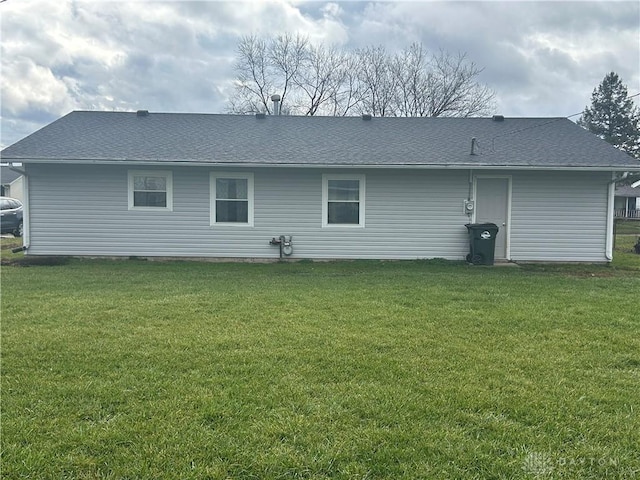 back of house featuring a yard