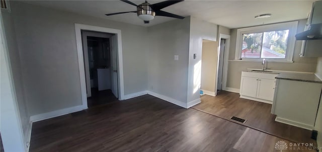 interior space with white cabinetry, sink, ceiling fan, dark hardwood / wood-style flooring, and ventilation hood