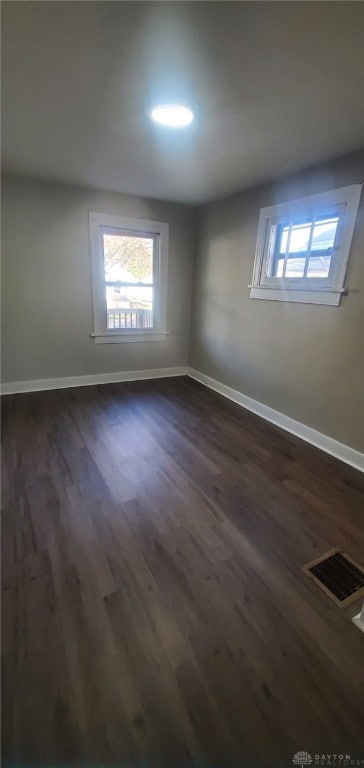 spare room featuring dark hardwood / wood-style flooring