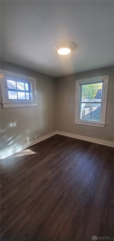 spare room featuring dark wood-type flooring