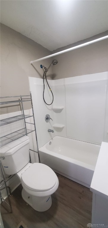 full bathroom featuring vanity, toilet, wood-type flooring, and tub / shower combination