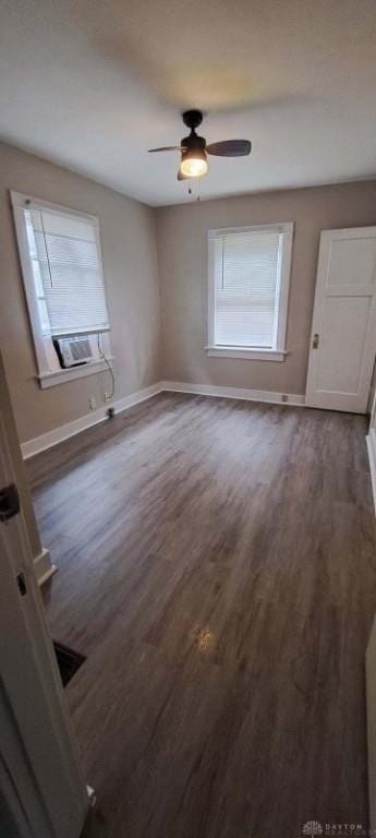 spare room featuring ceiling fan and dark wood-type flooring