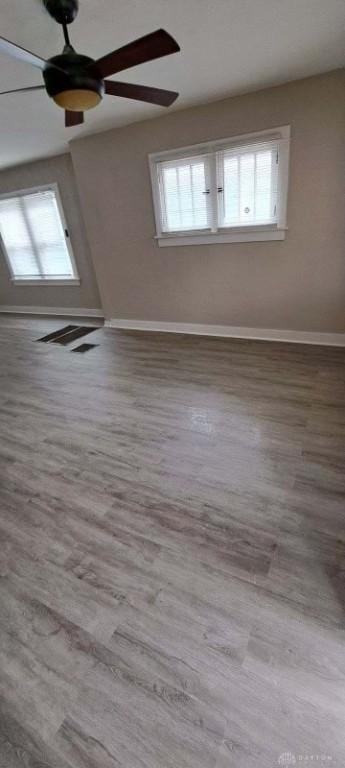 unfurnished room featuring ceiling fan and hardwood / wood-style floors