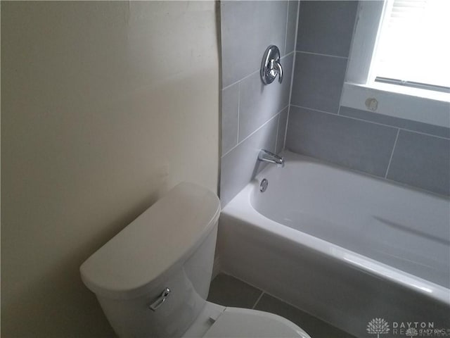 bathroom with tile patterned floors, toilet, and tub / shower combination