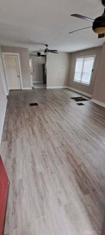 unfurnished living room featuring hardwood / wood-style flooring