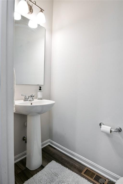 bathroom featuring wood-type flooring and sink