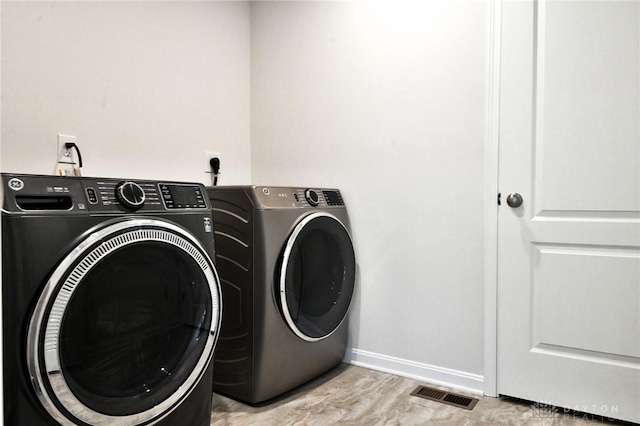 laundry room with separate washer and dryer