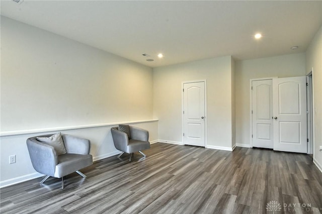 unfurnished room with dark wood-type flooring