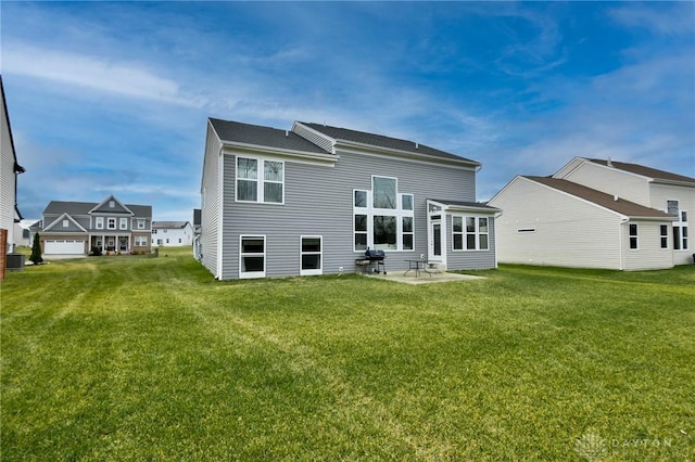 rear view of house with a yard and a patio area