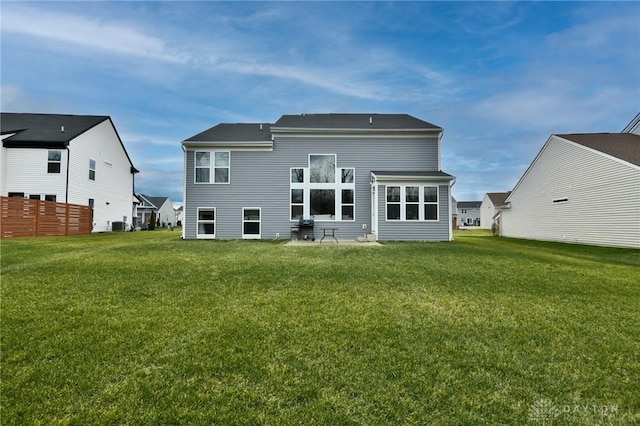 rear view of property with a yard