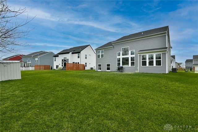 rear view of property featuring a lawn