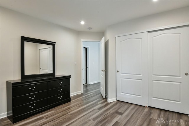 bedroom featuring hardwood / wood-style floors and a closet