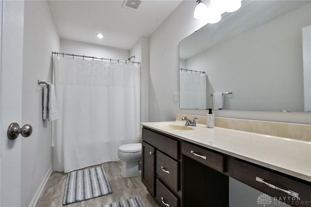 bathroom featuring wood-type flooring, vanity, toilet, and a shower with curtain