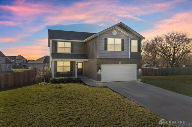 view of front of home with a lawn and a garage