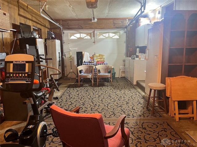 basement featuring washer and dryer and stainless steel fridge