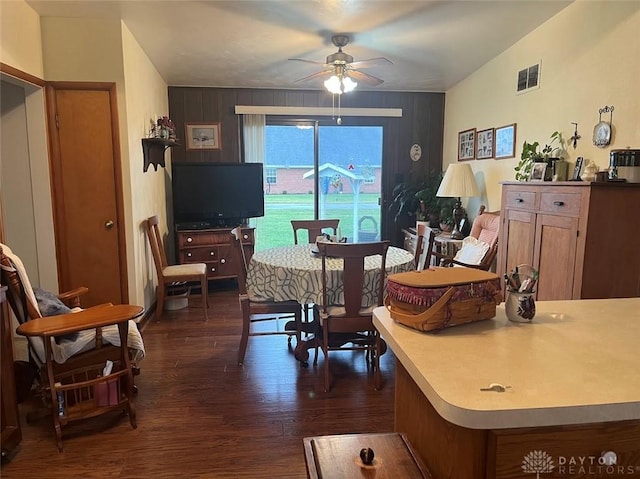 living room with ceiling fan and dark wood-type flooring